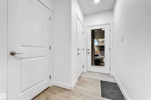 Entryway featuring light wood-finish flooring and bright white walls - 45 2710 66 Street, Edmonton, AB 