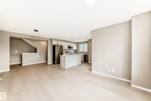 Expansive open-concept living area featuring light wood-finish flooring and neutral wall tones - 1210 Stoneside Road, Sherwood Park, AB - Indoor Photo Showing Kitchen