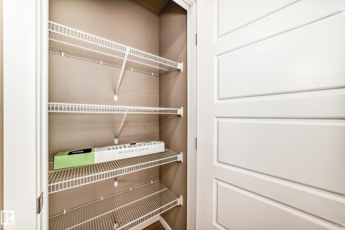 Interior closet featuring multiple white wire shelves, neutral wall color, and a white paneled door - 1210 Stoneside Road, Sherwood Park, AB - Indoor With Storage