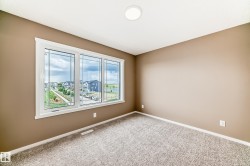 Expansive window featuring decorative grilles, white trim, and a surrounding neighborhood landscape - 