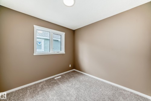 Room featuring neutral-toned walls, white trim, and a window with white casing - 1210 Stoneside Road, Sherwood Park, AB - Indoor Photo Showing Other Room