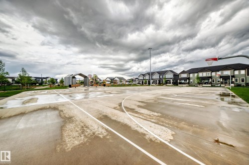 Outdoor basketball court featuring a red hoop and backboard - 1210 Stoneside Road, Sherwood Park, AB - Outdoor