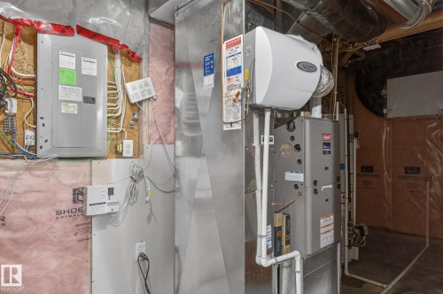 HVAC system with attached humidifier unit, electrical panel, and exposed ductwork - 64 South Creek Wynd, Stony Plain, AB 