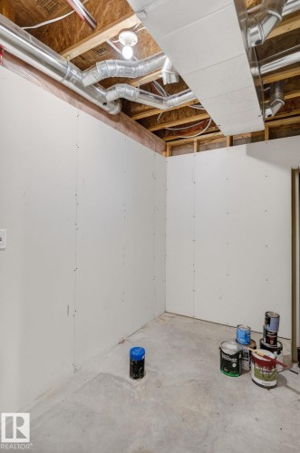 Unfinished lower level space with drywall-finished walls, exposed ceiling joists, and concrete flooring - 64 South Creek Wynd, Stony Plain, AB 