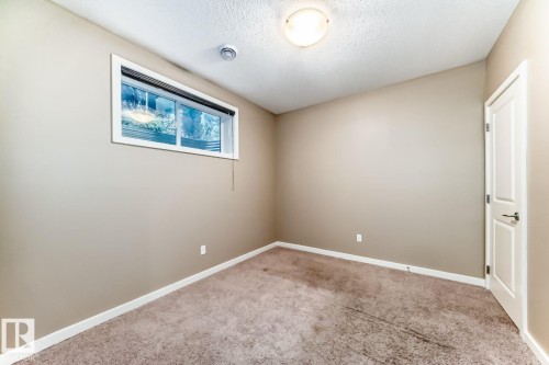 Room featuring a neutral wall color, white trim, and a window with a white frame - 4 11917 103 Street, Edmonton, AB 