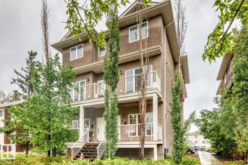 Multi-level building with stucco exterior and white trim windows - 4 11917 103 Street, Edmonton, AB 