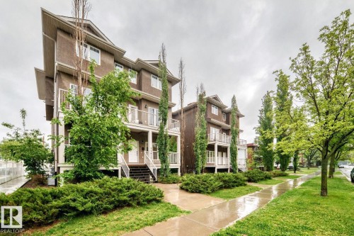 Contemporary townhome-style exterior with dark siding and white trim - 4 11917 103 Street, Edmonton, AB 