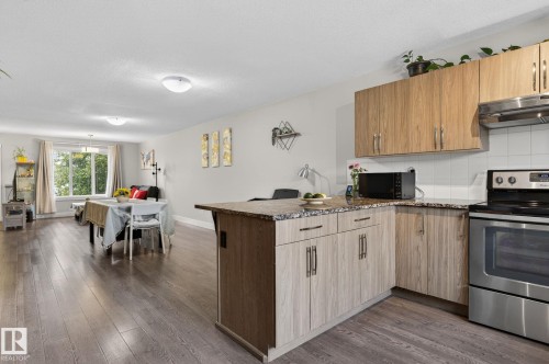 Open-concept living space with wood-finish flooring - 33 Durrand Bend, Fort Saskatchewan, AB 