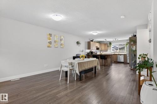 Open-concept living space featuring wood-finish flooring throughout - 33 Durrand Bend, Fort Saskatchewan, AB 