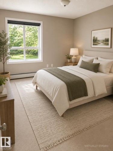 Carpeted room with a large window and neutral wall tones - 115 5340 199 Street, Edmonton, AB - Indoor Photo Showing Bedroom