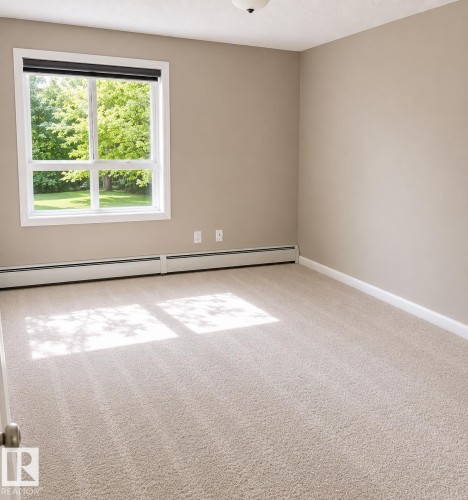 Spacious room with plush light-colored carpeting, neutral painted walls, and white trim - 115 5340 199 Street, Edmonton, AB - Indoor Photo Showing Other Room