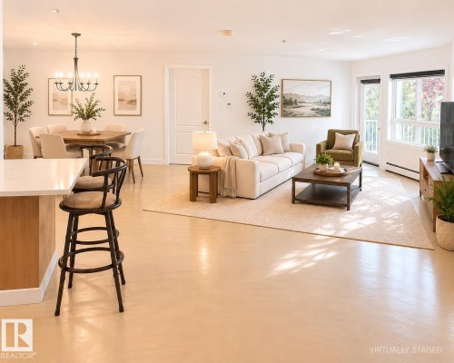 Open-concept living space featuring light-toned flooring and white walls - 115 5340 199 Street, Edmonton, AB - Indoor Photo Showing Living Room
