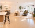 Open-concept living space featuring light-toned flooring and white walls - 115 5340 199 Street, Edmonton, AB  - Indoor Photo Showing Living Room 