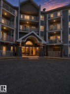 Multi-story residential building featuring balconies with white railings - 