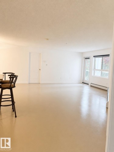 Expansive living area with neutral color palette and light-toned flooring - 115 5340 199 Street, Edmonton, AB - Indoor Photo Showing Other Room