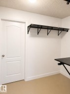White paneled door with round knob, white baseboards, and light-colored flooring - 