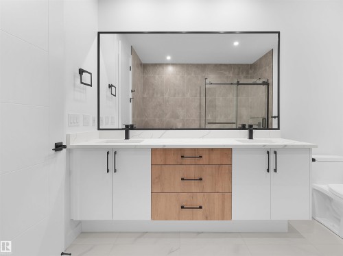 Dual vanity with undermount sinks, quartz countertop, and matte black fixtures - 214 Crystal Creek Drive, Leduc, AB 