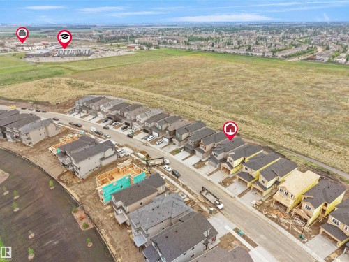 Aerial perspective showcasing a developing residential community with detached and attached housing units, some under construction - 214 Crystal Creek Drive, Leduc, AB 