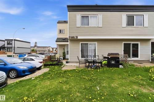 Two-story exterior with light-toned siding and dark trim - 203 11421 34 Street Nw, Edmonton, AB 