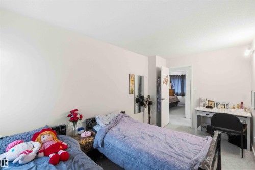 Room featuring light-colored walls and carpeted flooring - 203 11421 34 Street Nw, Edmonton, AB 