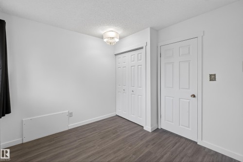 Room featuring wood-finish flooring and a neutral color palette - 14808 55 Street, Edmonton, AB 