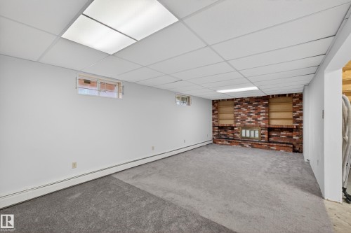 Spacious interior room with light gray carpeting and white painted walls - 14808 55 Street, Edmonton, AB 