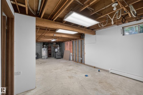 Unfinished basement space featuring exposed wood joists and concrete flooring - 14808 55 Street, Edmonton, AB 