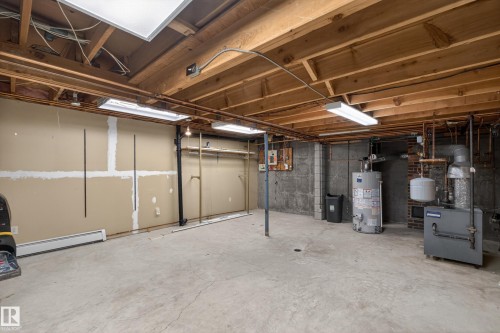 Unfinished basement featuring exposed wood joists and concrete flooring - 14808 55 Street, Edmonton, AB 