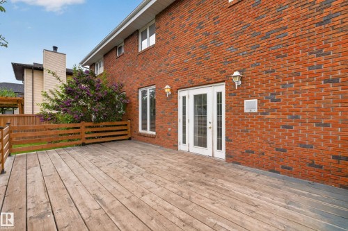 Expansive wood deck with a partial wood railing - 14808 55 Street, Edmonton, AB 