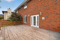 Expansive wood deck with a partial wood railing - 