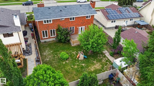 Red brick exterior with white trim windows and a grey shingled roof - 14808 55 Street, Edmonton, AB 