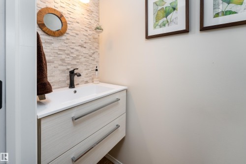 2 pc bath with wall-mounted vanity with integrated sink, and matte black faucet - 5964 South Terwillegar Boulevard, Edmonton, AB 