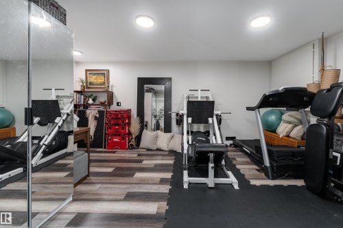 Recreation room in basement with vinyl flooring, currently a dedicated exercise area - 5964 South Terwillegar Boulevard, Edmonton, AB 