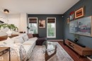 Living area featuring dark accent wall, wood-finish flooring, and two large windows with woven shades - 5964 South Terwillegar Boulevard, Edmonton, AB 