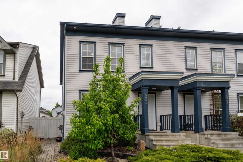 Light-colored horizontal siding facade with dark trim accents - 5964 South Terwillegar Boulevard, Edmonton, AB 