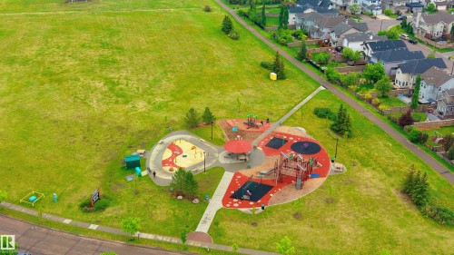 Expansive community park featuring a playground with multiple structures, sand play areas, and a covered picnic shelter - 5964 South Terwillegar Boulevard, Edmonton, AB 