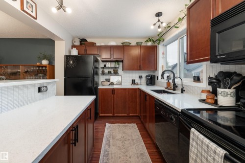 Full kitchen featuring solid maple cabinetry, quartz countertops, and imported tile backsplash - 5964 South Terwillegar Boulevard, Edmonton, AB 