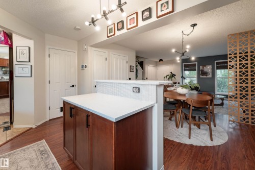 Kitchen island featuring maple cabinetry, quartz countertop, and custom tile from New York! - 5964 South Terwillegar Boulevard, Edmonton, AB 