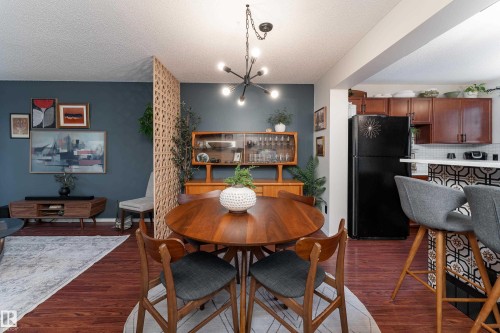 Spacious dining area featuring a contemporary chandelier - 5964 South Terwillegar Boulevard, Edmonton, AB 