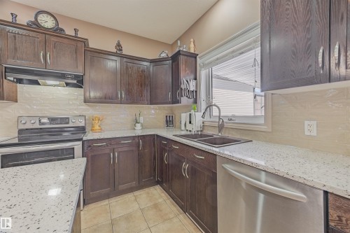 Fridge changed in 2024. Dishwasher and Stove purchased in 2015. Quartz countertops & kitchen backsplash done in 2022. - 57 Homestead Crescent, Edmonton, AB 