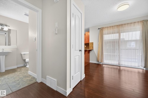 Hardwood-finish flooring extending from the entryway - 48 8716 179 Avenue, Edmonton, AB 