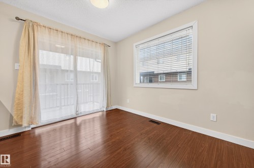Expansive wood-finish flooring extending throughout the room - 48 8716 179 Avenue, Edmonton, AB 