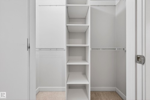 Integrated custom closet system featuring adjustable shelving and hanging rods - 48 8716 179 Avenue, Edmonton, AB 