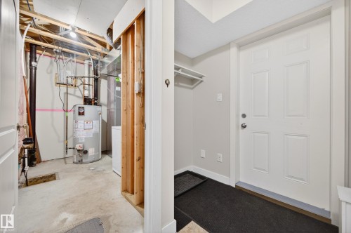 Unfinished basement area with exposed ceiling joists and utility infrastructure - 48 8716 179 Avenue, Edmonton, AB 