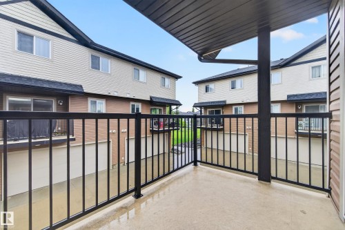 Private balcony featuring a concrete surface and black metal railing - 48 8716 179 Avenue, Edmonton, AB 