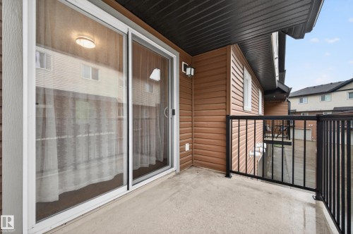 Private concrete balcony with black metal railings - 48 8716 179 Avenue, Edmonton, AB 