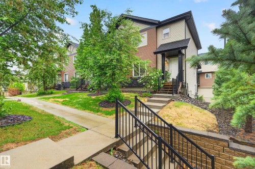 Two-story residence featuring light-colored siding and a contrasting brown facade - 48 8716 179 Avenue, Edmonton, AB 