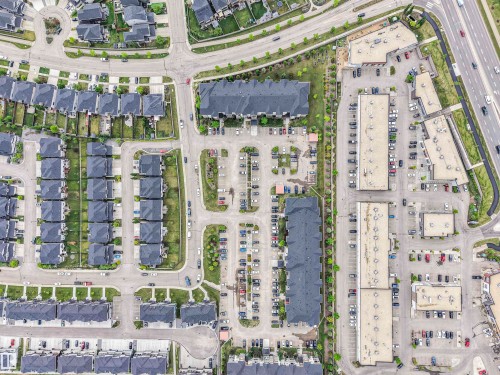 Aerial perspective showcasing a structured neighborhood layout with residential and commercial properties - 1103 2 Augustine Crescent, Sherwood Park, AB 