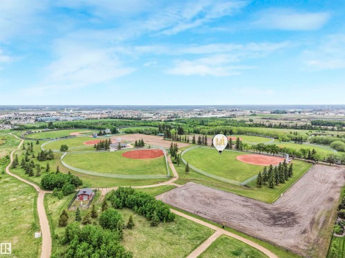 Expansive green spaces featuring multiple baseball diamonds, walking paths, mature trees, and open fields - 1103 2 Augustine Crescent, Sherwood Park, AB 