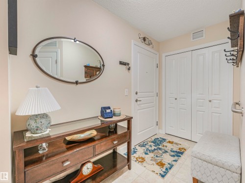 Entryway featuring light-toned walls, tile flooring, and a white paneled entry door - 1103 2 Augustine Crescent, Sherwood Park, AB 
